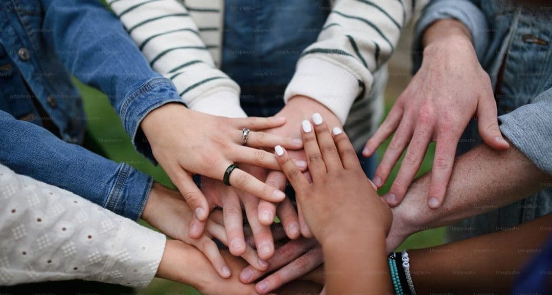 Hands joined together at a community gathering